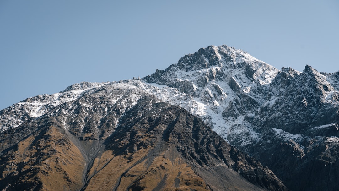 Snow-capped mountain peak against a clear blue sky