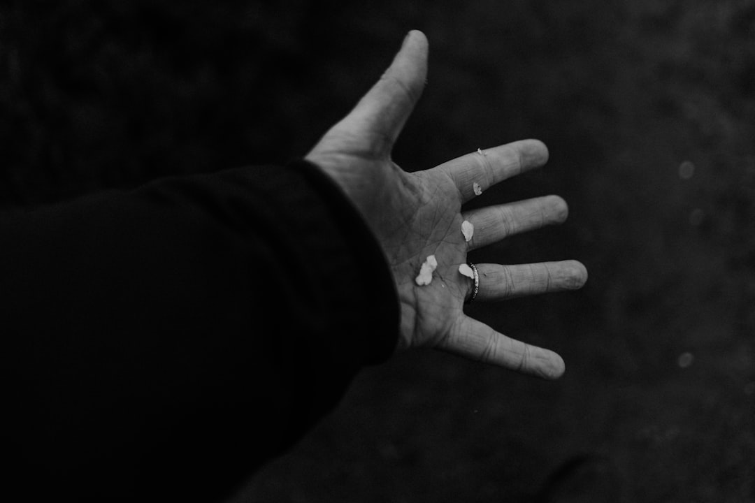 A hand with small white objects in palm