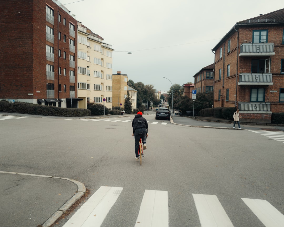 A man riding a skateboard down a street next to tall buildings