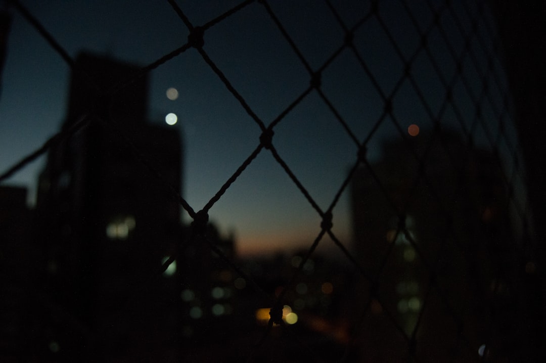 black metal fence during night time