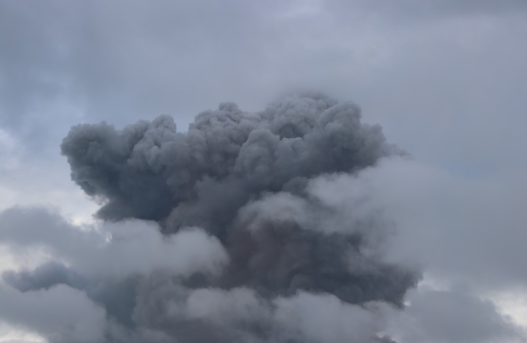 a large plume of smoke billowing out of the sky
