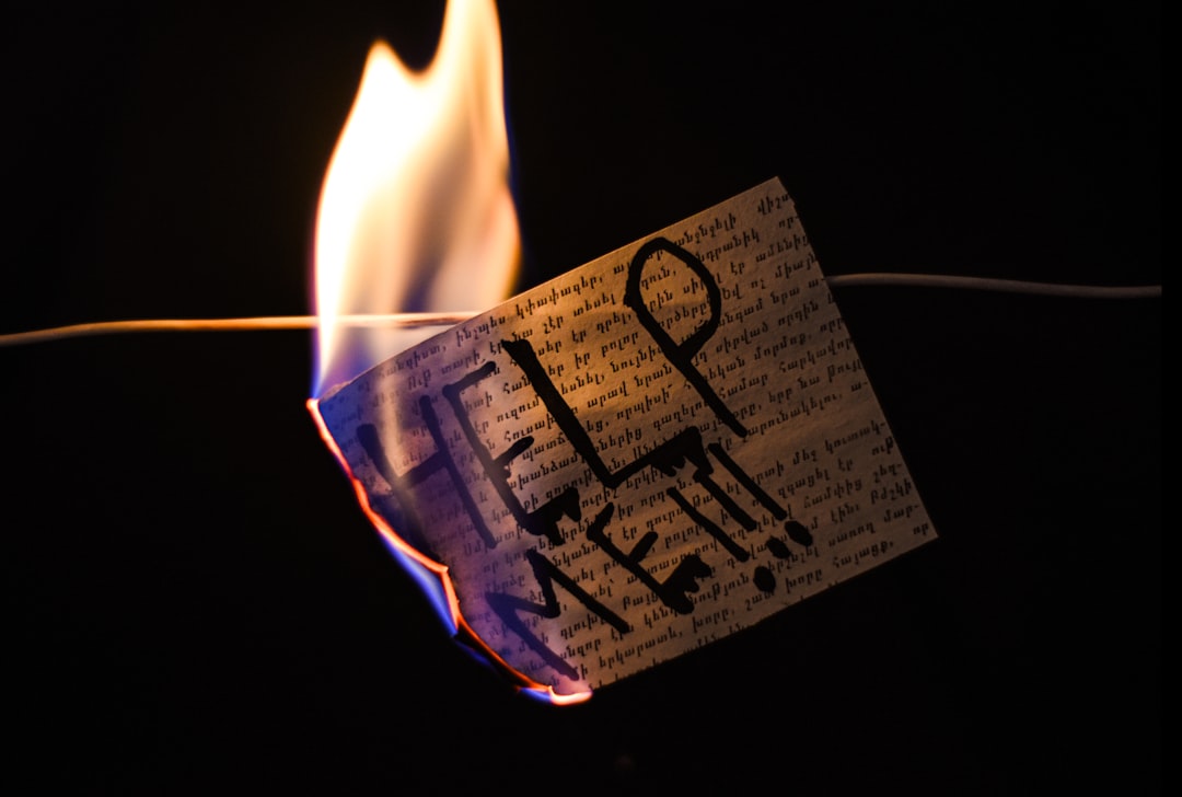 A note with "help me!!!" written on it burns.
