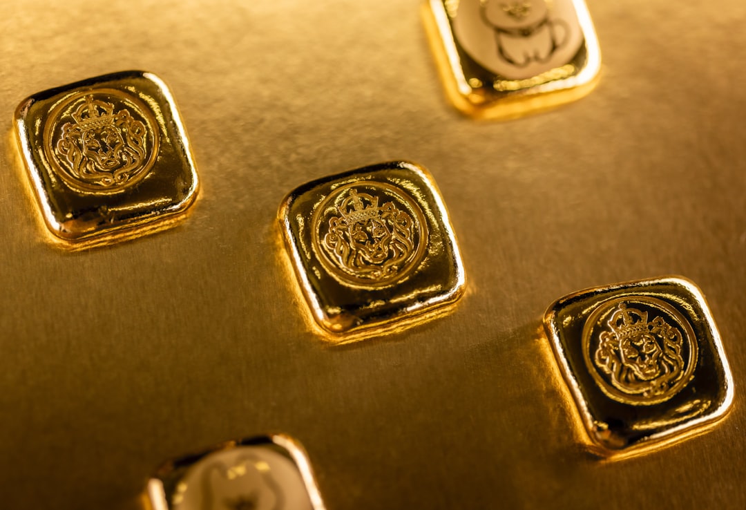 Several gold bars with intricate designs scattered
