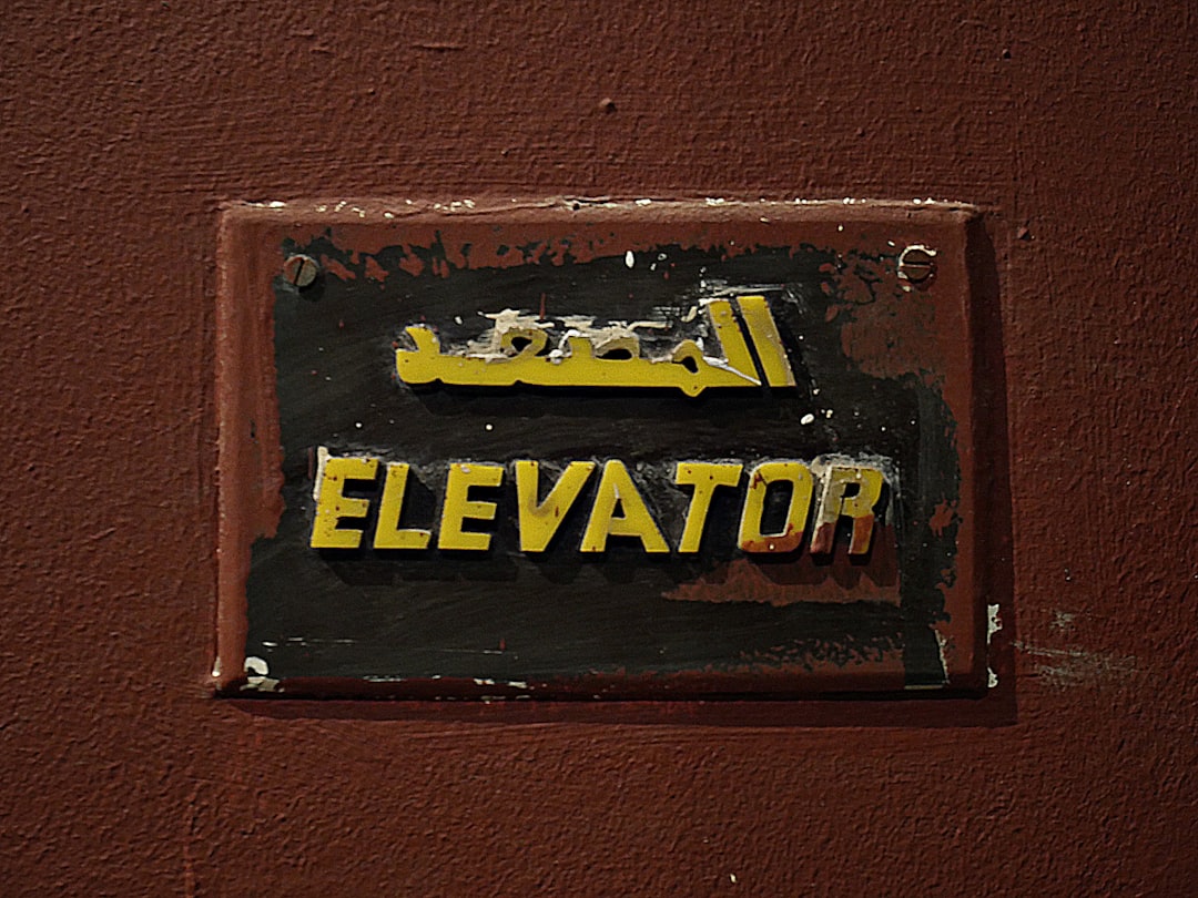 Close-up of a weathered elevator sign